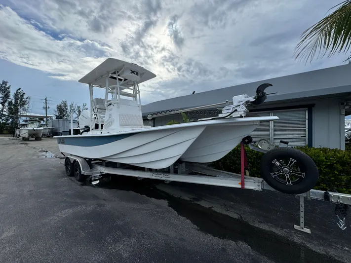  Yacht Photos Pics 2025 Shallow Sport 25 X3 boat on a trailer, parked outdoors.