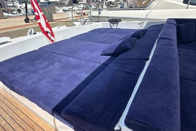  Yacht Photos Pics Luxurious 1987 MAGNUM MARINE 63 yacht with plush blue deck seating.