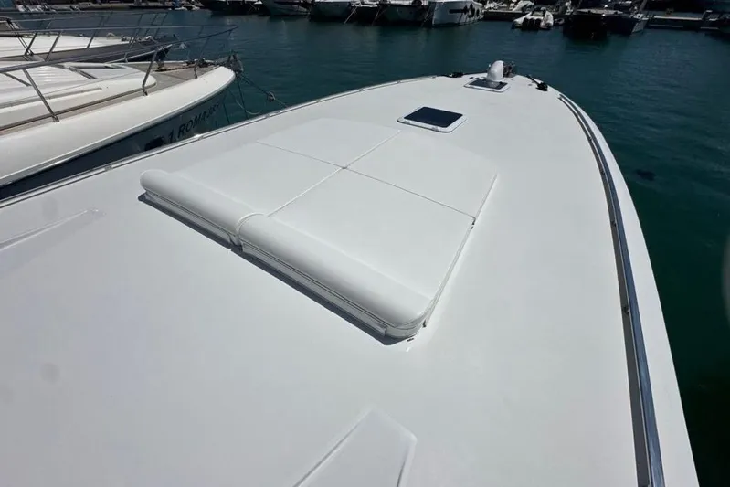  Yacht Photos Pics 1987 MAGNUM MARINE 63 yacht deck, sleek design, docked in marina.