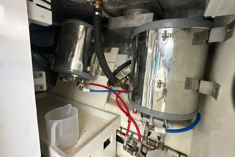  Yacht Photos Pics Engine room of 1987 MAGNUM MARINE 63 with metal components and hoses.