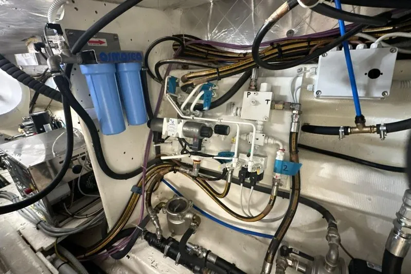  Yacht Photos Pics Engine room of 1987 MAGNUM MARINE 63 with complex wiring and filtration system.