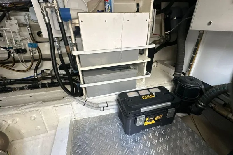  Yacht Photos Pics Engine room of a 1987 MAGNUM MARINE 63 yacht with tools and equipment.