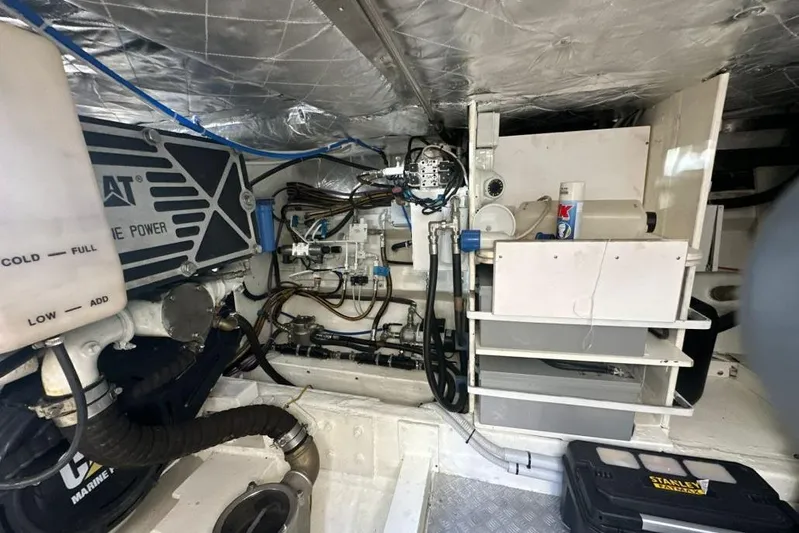  Yacht Photos Pics Engine room of 1987 MAGNUM MARINE 63 yacht, showcasing mechanical components and equipment.