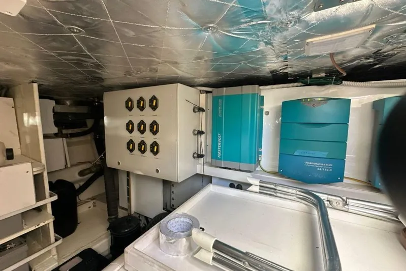  Yacht Photos Pics Engine room of 1987 MAGNUM MARINE 63 with electrical panels and equipment.