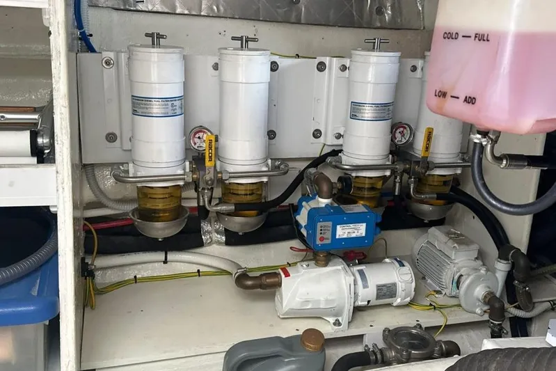  Yacht Photos Pics Engine room of 1987 MAGNUM MARINE 63 with fuel filters and mechanical components.
