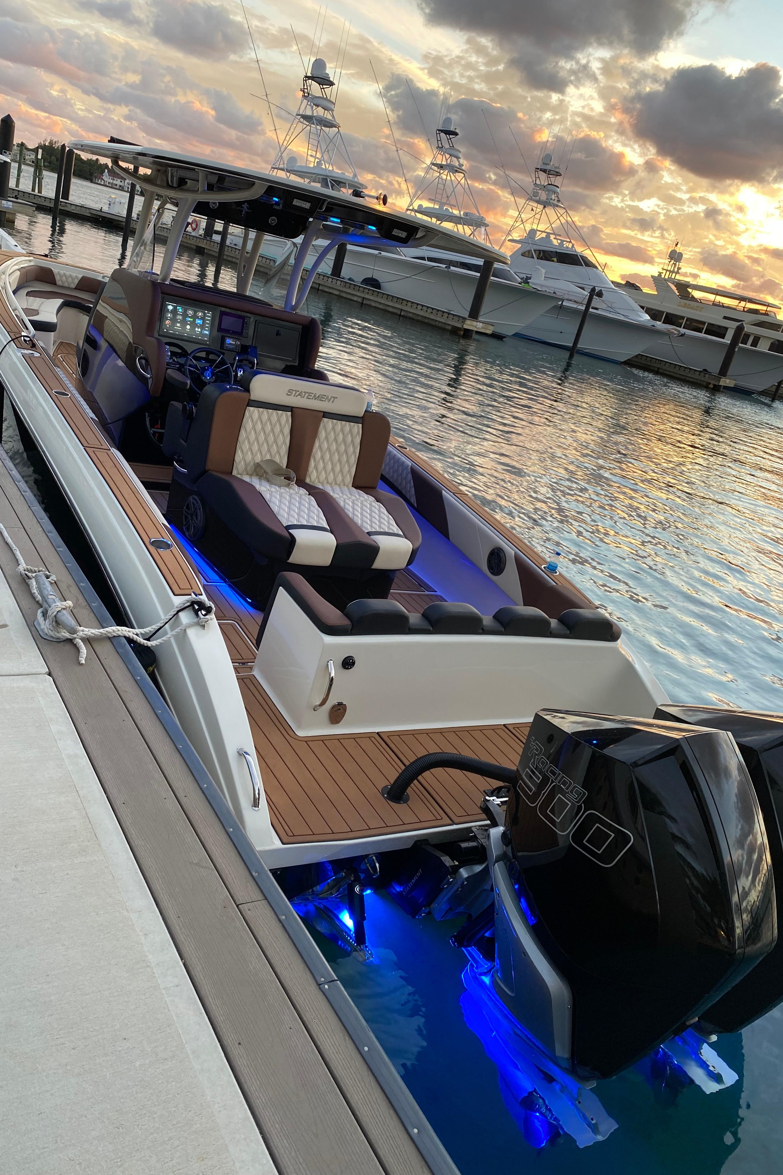 2021 Statement 350 Open boat docked at sunset with illuminated blue underwater lights.