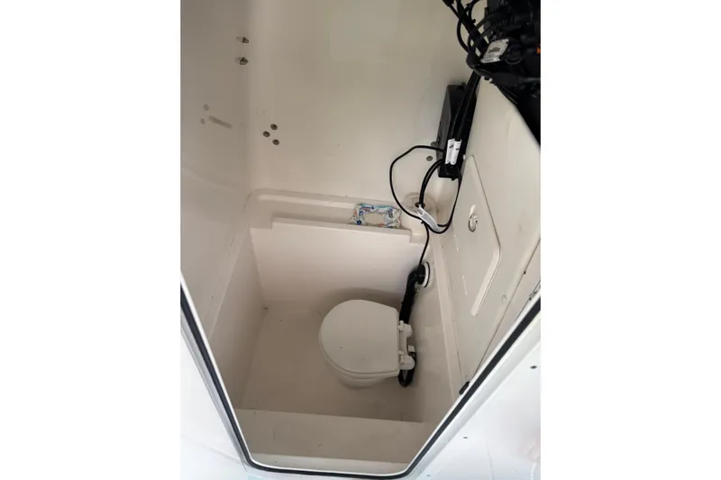  Yacht Photos Pics 2023 Contender 28 Sport boat interior with compact marine toilet.
