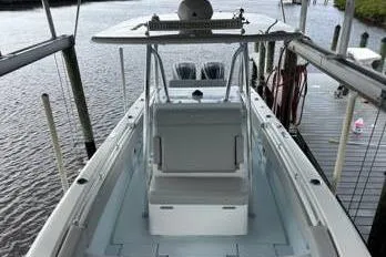  Yacht Photos Pics 2023 Contender 28 Sport boat docked, showcasing spacious deck and seating.