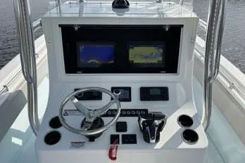  Yacht Photos Pics 2023 Contender 28 Sport boat dashboard with dual screens and steering wheel.