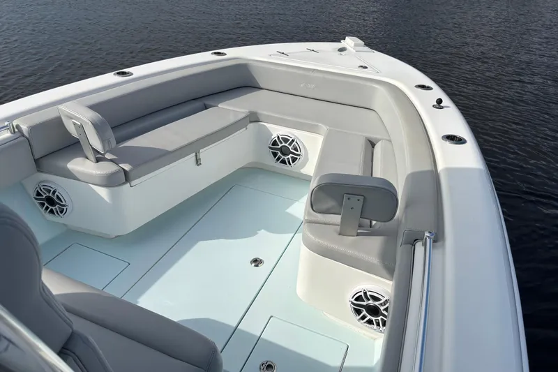  Yacht Photos Pics 2023 Contender 28 Sport boat interior with cushioned seating and speakers.