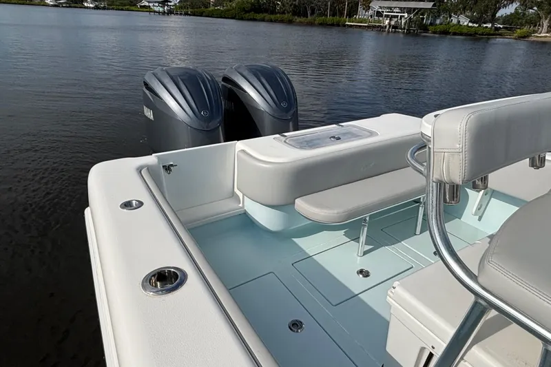  Yacht Photos Pics 2023 Contender 28 Sport boat with dual Yamaha engines on a calm waterway.