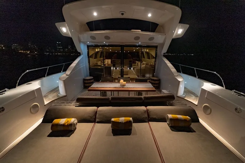 Houdini Yacht Photos Pics Luxurious 2007 Mangusta 92 yacht deck at night, featuring elegant seating and ambient lighting.