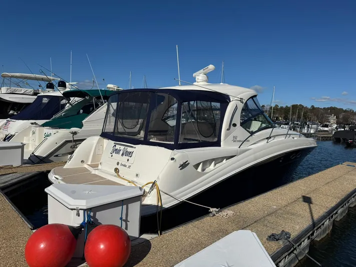  Yacht Photos Pics 2004 Sea Ray 390 Sundancer docked at marina, featuring sleek design and enclosed cockpit.