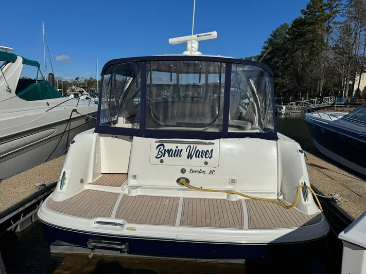  Yacht Photos Pics 2004 Sea Ray 390 Sundancer docked, rear view with "Brain Waves" name visible.