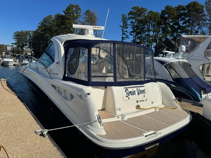  Yacht Photos Pics 2004 Sea Ray 390 Sundancer docked at marina, featuring sleek design and spacious deck.