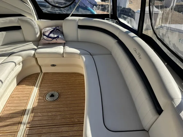  Yacht Photos Pics Luxurious interior of 2004 Sea Ray 390 Sundancer with plush seating and wooden flooring.