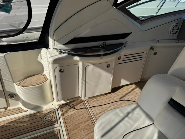  Yacht Photos Pics 2004 Sea Ray 390 Sundancer interior with wood flooring and compact kitchenette.