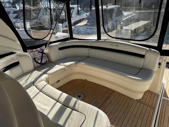  Yacht Photos Pics 2004 Sea Ray 390 Sundancer interior with white leather seating and wood flooring.