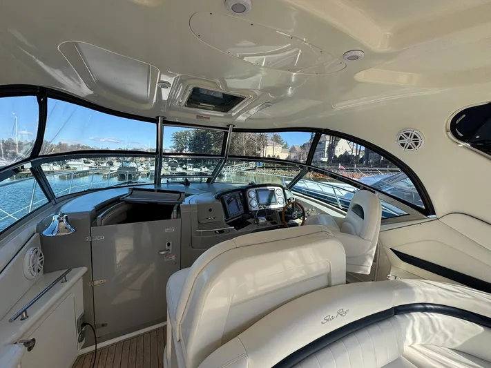  Yacht Photos Pics 2004 Sea Ray 390 Sundancer cockpit with luxurious seating and modern navigation equipment.