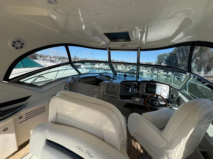  Yacht Photos Pics Interior view of 2004 Sea Ray 390 Sundancer yacht cockpit with helm and seating.