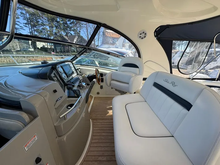  Yacht Photos Pics 2004 Sea Ray 390 Sundancer cockpit with plush seating and modern dashboard.