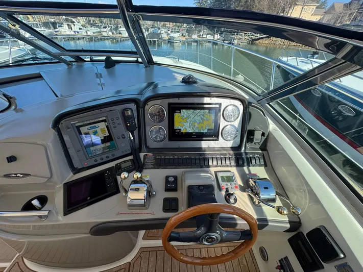  Yacht Photos Pics 2004 Sea Ray 390 Sundancer helm with navigation screens and controls, docked at marina.