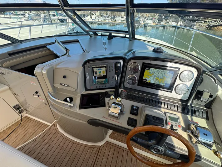  Yacht Photos Pics 2004 Sea Ray 390 Sundancer helm with navigation screens and wooden steering wheel.