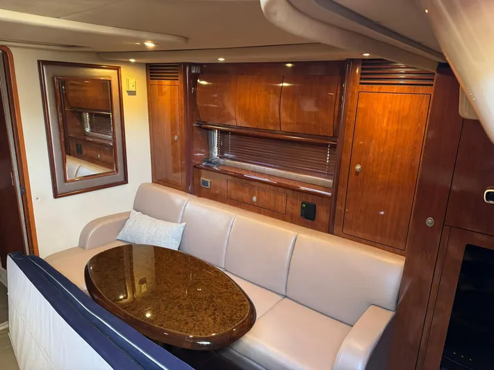 Yacht Photos Pics Luxurious interior of 2004 Sea Ray 390 Sundancer with elegant wood cabinetry and plush seating.