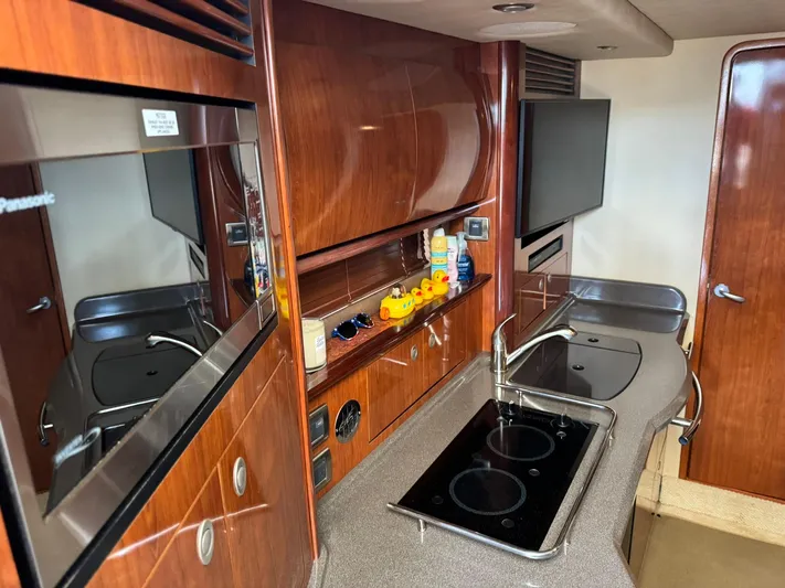  Yacht Photos Pics Luxurious 2004 Sea Ray 390 Sundancer yacht kitchen with modern amenities and sleek design.