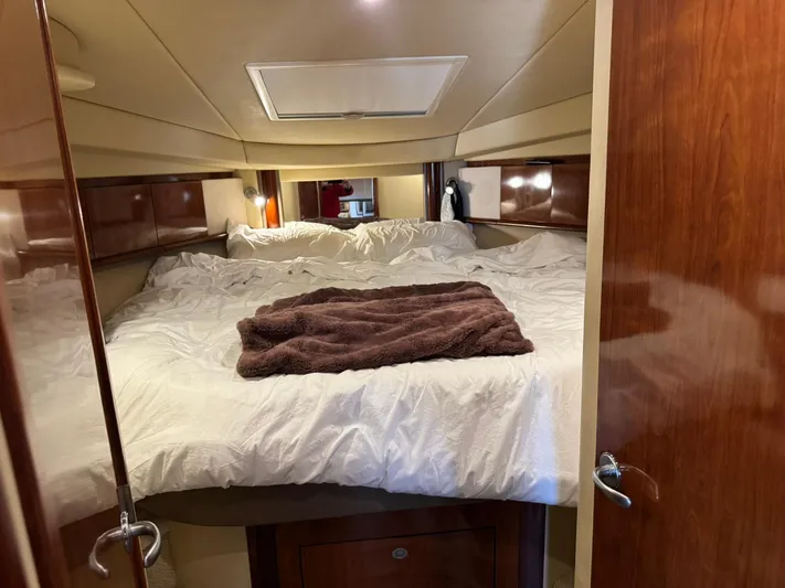  Yacht Photos Pics Cozy cabin interior of 2004 Sea Ray 390 Sundancer with plush bedding and wooden accents.