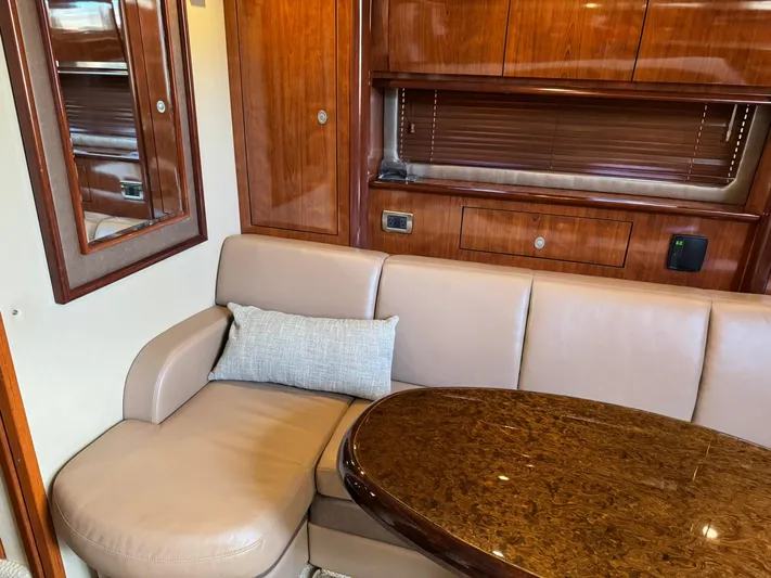  Yacht Photos Pics Luxurious interior of 2004 Sea Ray 390 Sundancer with leather seating and wooden accents.