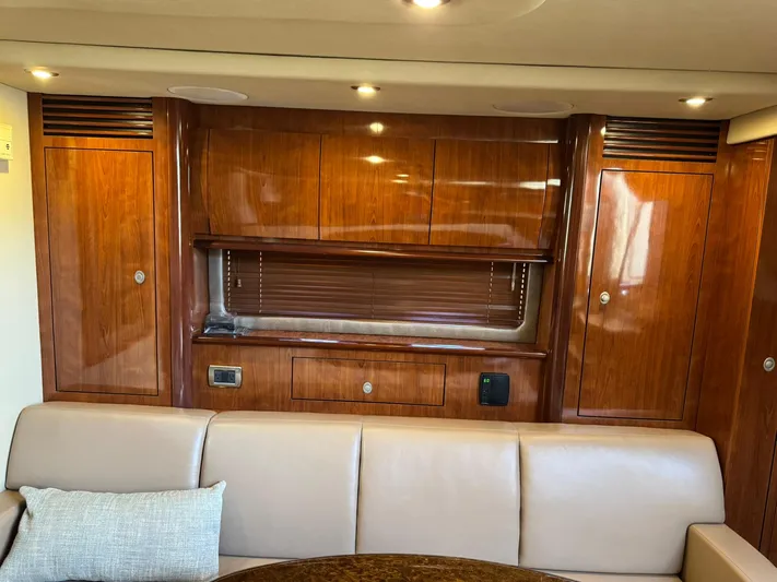  Yacht Photos Pics Interior of 2004 Sea Ray 390 Sundancer with polished wood cabinets and beige seating.