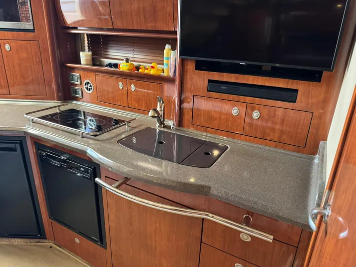  Yacht Photos Pics Luxurious kitchen area in 2004 Sea Ray 390 Sundancer yacht with modern amenities.