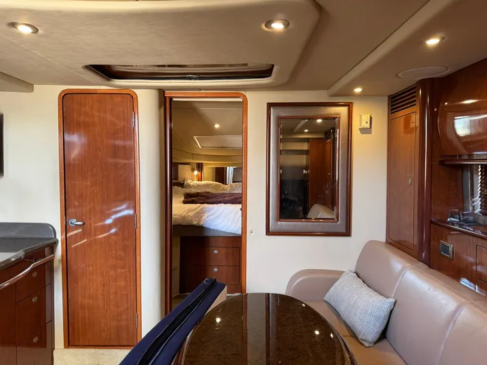  Yacht Photos Pics Luxurious interior of 2004 Sea Ray 390 Sundancer yacht with wood finishes and cozy seating.
