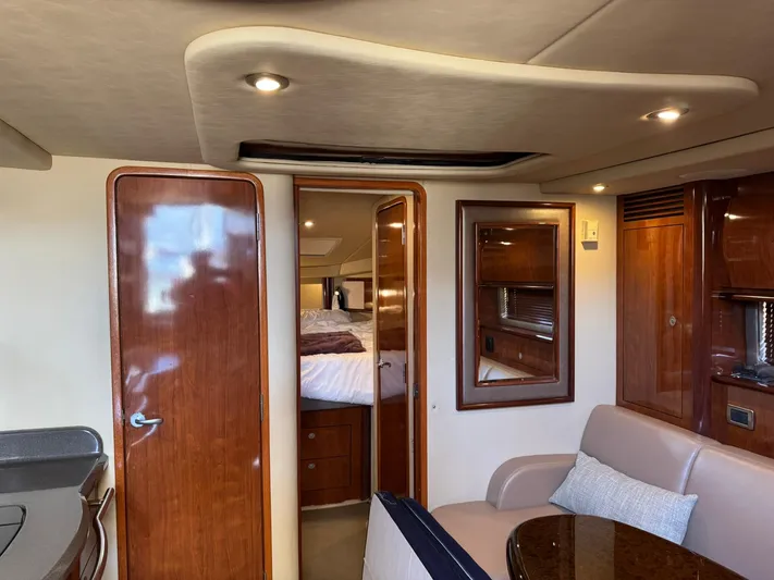 Yacht Photos Pics Interior of 2004 Sea Ray 390 Sundancer yacht, featuring wood finishes and cozy seating.