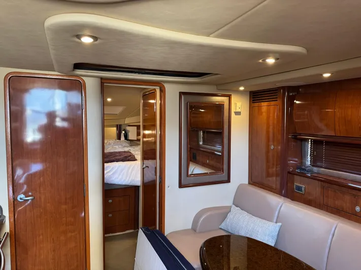  Yacht Photos Pics Interior of 2004 Sea Ray 390 Sundancer yacht with elegant wood finishes and cozy seating.