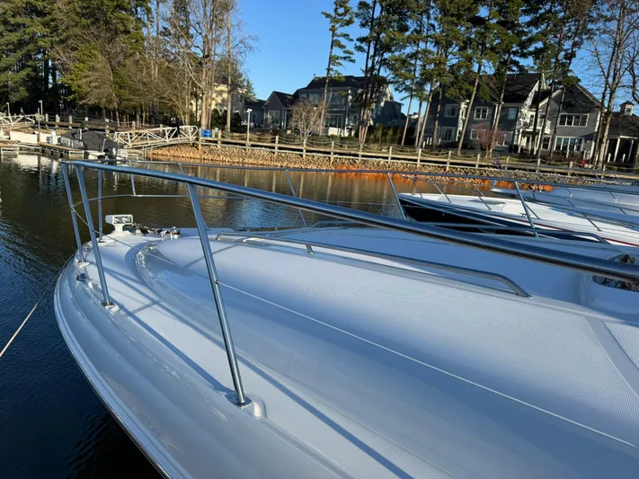  Yacht Photos Pics 2004 Sea Ray 390 Sundancer docked by waterfront homes and trees.