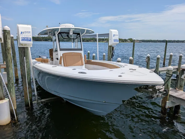 Under Pressure Yacht Photos Pics 2020 Sea Hunt Gamefish 30 boat docked, featuring forward seating and sleek design.