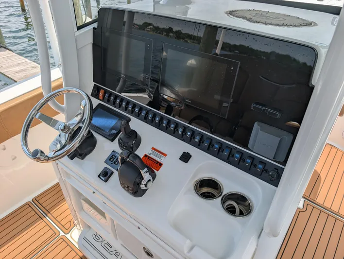 Under Pressure Yacht Photos Pics 2020 Sea Hunt Gamefish 30 boat console with steering wheel and electronic controls.