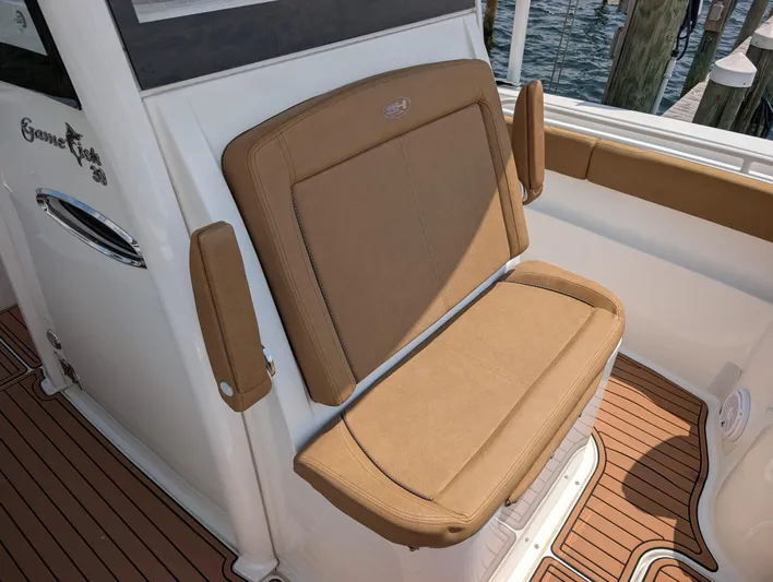 Under Pressure Yacht Photos Pics 2020 Sea Hunt Gamefish 30 Forward Seating with tan upholstery and teak-style flooring.