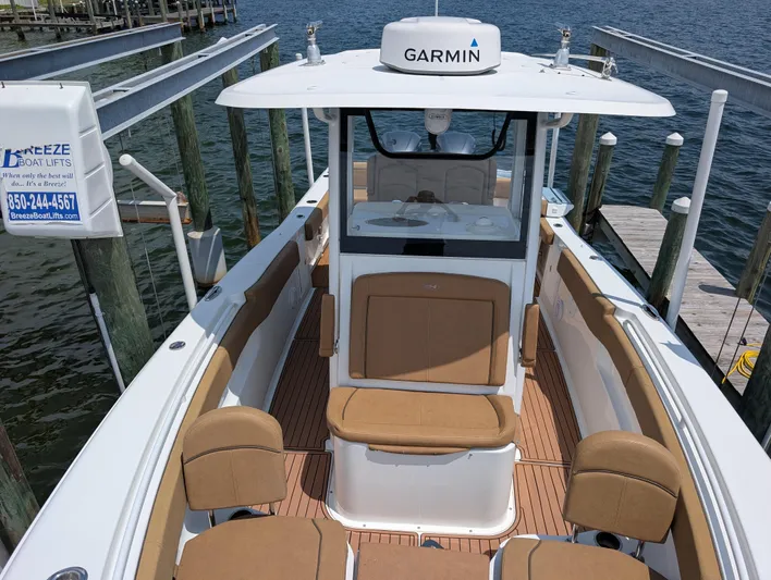 Under Pressure Yacht Photos Pics 2020 Sea Hunt Gamefish 30 boat with forward seating, docked near water.