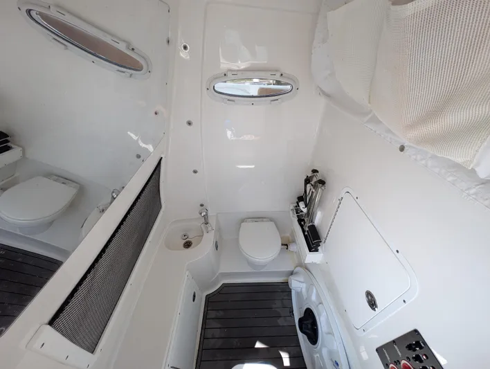 Under Pressure Yacht Photos Pics Interior of 2020 Sea Hunt Gamefish 30 boat, featuring a compact marine toilet and storage area.