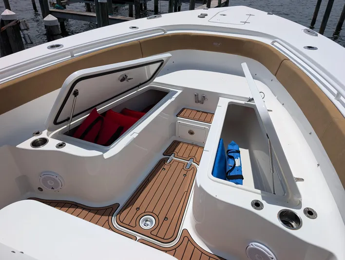 Under Pressure Yacht Photos Pics 2020 Sea Hunt Gamefish 30 Forward Seating with open storage compartments and teak flooring.