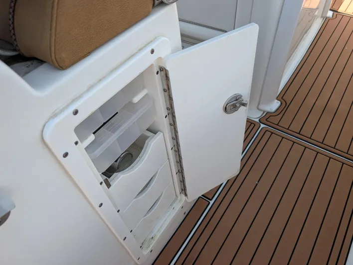 Under Pressure Yacht Photos Pics Open storage compartment on 2020 Sea Hunt Gamefish 30 boat with teak flooring.