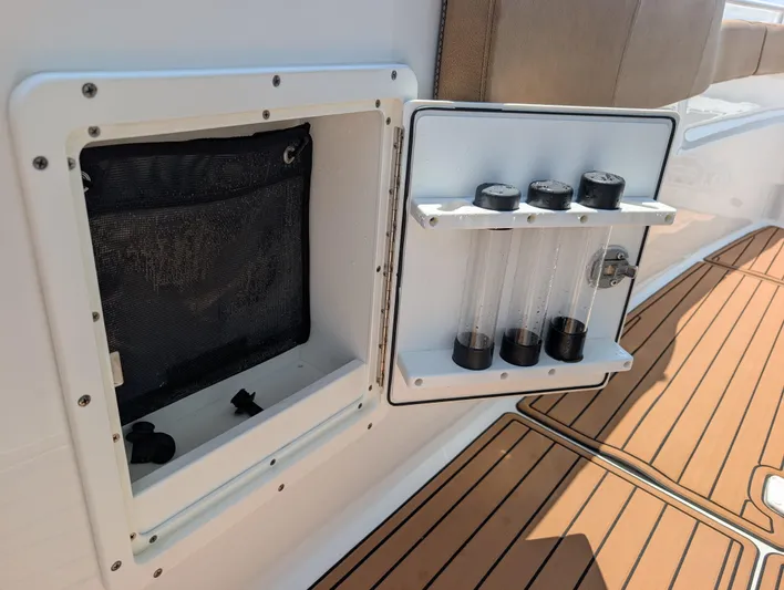 Under Pressure Yacht Photos Pics 2020 Sea Hunt Gamefish 30 storage compartment with tackle tubes on teak deck.