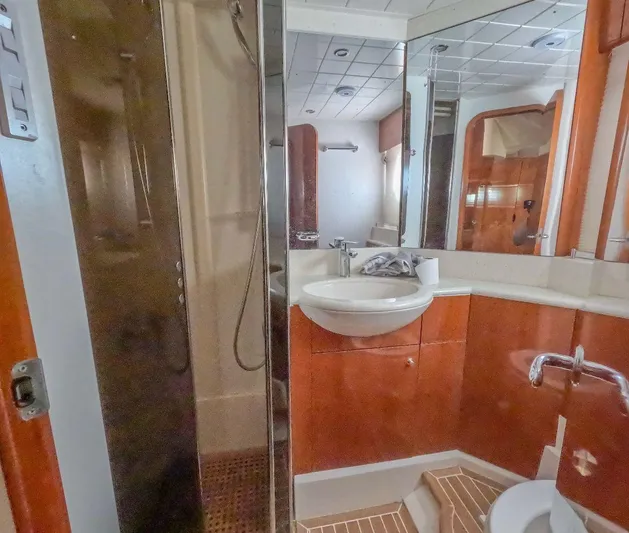 Incentive Yacht Photos Pics Luxurious bathroom in 2004 Princess 65 yacht with modern fixtures and wood accents.