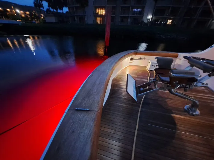 Mary Rose Yacht Photos Pics Hatteras 68 Convertible 2006 yacht deck with red underwater lights at night.