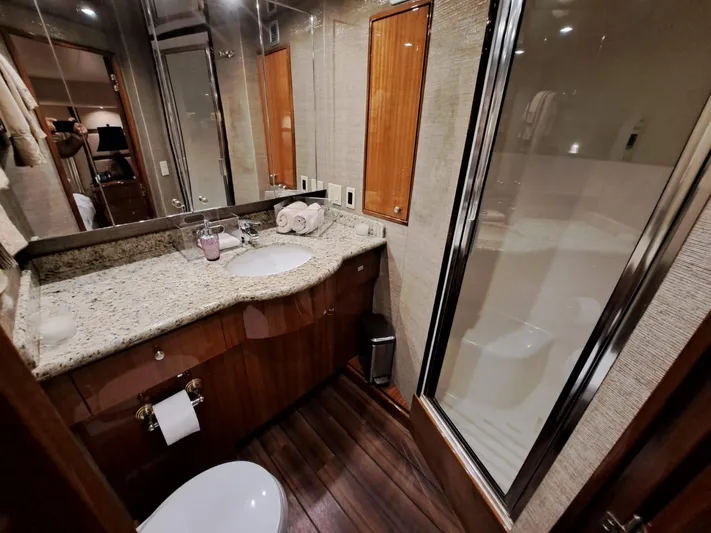 Mary Rose Yacht Photos Pics Luxurious bathroom in 2006 Hatteras 68 Convertible yacht with granite countertop and glass shower.