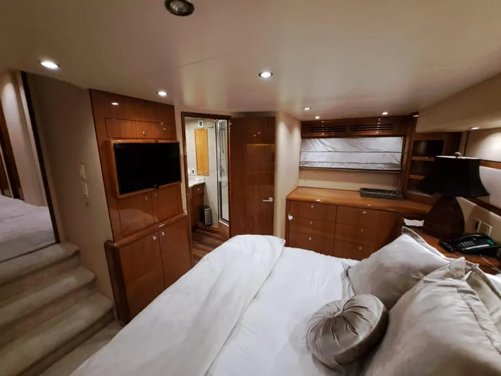 Mary Rose Yacht Photos Pics Luxurious bedroom interior of 2006 Hatteras 68 Convertible yacht with modern amenities.