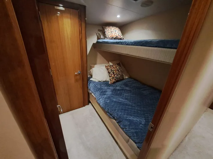 Mary Rose Yacht Photos Pics Bunk beds in 2006 Hatteras 68 Convertible yacht cabin with wooden door.
